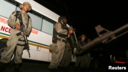 Indonesia's anti-terror police stand guard at the site of a shooting at a hotel in Sanur on the Indonesian island of Bali, March 18, 2012.