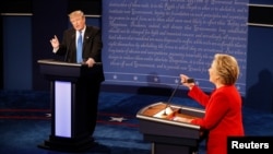 FILE - Then-candidates Donald Trump and Hillary Clinton speak simultaneously during their first presidential debate at Hofstra University in Hempstead, N.Y., Sept. 26, 2016.