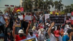 Demonstrators display placards during a protest close to Indonesian Embassy in Yangon, Myanmar, Tuesday, Feb. 23, 2021. Anti-coup protesters gathered outside the embassy following reports that Indonesia was seeking to have fellow members of the…