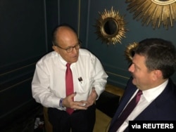 Ukrainian lawmaker Andriy Derkach attends a meeting with then-U.S. President Donald Trump's personal lawyer Rudolph Giuliani in Kyiv, in this undated photo obtained from social media.