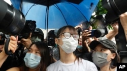 Agnes Chow, center, a prominent pro-democracy activist sentenced to jail last year for her role in an unauthorized protest, is released in Hong Kong, June 12, 2021. 