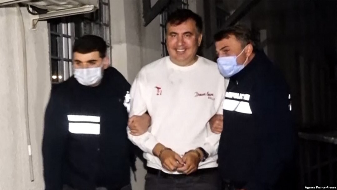 This screengrab shows former Georgia President Mikheil Saakashvili escorted by police officers in Tbilisi on Oct. 1, 2021, following his arrest upon his return from exile. (Photo by Handout / Interior Ministry of Georgia / AFP)