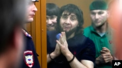 Zaur Dadayev, center left, Anzor Gubashev, center, and Shadid Gubashev, center right, listen to the sentence in a court room in Moscow, Russia, July 13, 2017. 