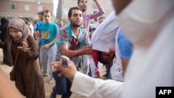 Egyptian supporters of the Muslim Brotherhood movement carry the body of Hossam Al-Akabawi, a comrade who died during clashes with Egyptian police following a march after the morning prayers for Eid al-Fitr, July 17, 2015 in the village of Nahya near Cairo.