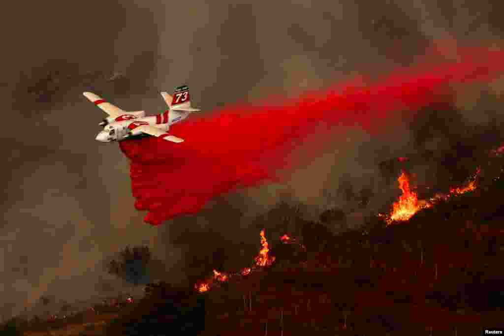 An aerial tanker combats the Airport Fire, a wildfire burning in the hills of Orange County, California, Sept. 9, 2024. 