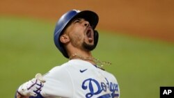 Los Angeles Dodgers' Mookie Betts celebrates after a home run against the Tampa Bay Rays during the eighth inning in Game 6 of the baseball World Series, Oct. 27, 2020, in Arlington, Texas. 