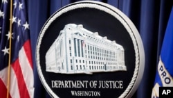 FILE - The logo for the Justice Department is seen before a news conference at the Department of Justice, Aug. 23, 2024, in Washington. 