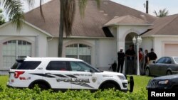 Police stand in front of one of the houses that officials indicated was connected to the Orlando shooter in Port St. Lucie, Florida, U.S. June 12, 2016. 