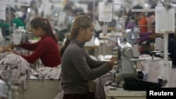 FILE - Employees work at a factory supplier of the H&M brand in Kandal province, Cambodia, on December 12, 2018.