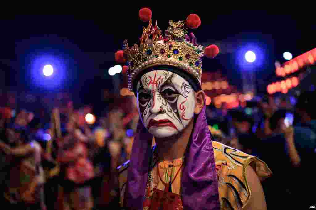 A participant from Taiwan performs during the Cap Go Meh festival, marking the 15th and final day of the Lunar New Year celebrations, in Bogor, West Java.