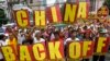 Protesters supporting the Philippines' claims over Scarborough Shoal march towards the Chinese consulate in Manila's Makati financial district on May 11, 2012. (Erik De Castro/Reuters)