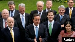 FILE - Britain's Prime Minister David Cameron (front C) is pictured with some members of his cabinet in a May 2010 group picture in the garden of 10 Downing Street in London.