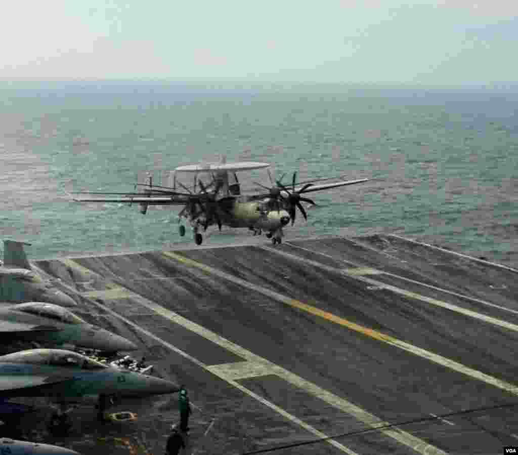 An E-2 "Hawkeye" early warning/battle management aircraft lumbers onto the wet deck of the USS George Washington in the Yellow Sea, June 24, 2012. (VOA/S. Herman)