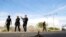 FILE - A tire-puncture device is seen as policemen patrol an area affected by blockades set by members of Santa Rosa de Lima Cartel to repel security forces during a police operation on the outskirts of Celaya, in Guanajuato state, Mexico, March 10, 2020.