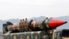 FILE - Pakistani military personnel stand beside a Shaheen III surface-to-surface ballistic missile during a Pakistan Day military parade in Islamabad, March 23, 2019. 