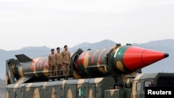 FILE - Pakistani military personnel stand beside a surface-to-surface ballistic missile during a Pakistan Day military parade in Islamabad on March 23, 2019. A White House official said on Dec. 19, 2024, that Pakistan is developing missile capabilities that could reach the U.S.