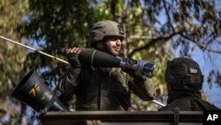Israeli soldiers load ammunition onto an Armored Personnel Carrier (APC) at a staging ground near the Israel-Gaza border, Friday, May 14, 2021. (AP Photo/Tsafrir Abayov)