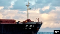 FILE - The Chinese bulk carrier Yi Peng 3 is anchored and being monitored by a Danish naval patrol vessel (unseen) in the sea of Kattegat, near the City og Granaa in Jutland, Denmark, on Nov. 20, 2024.