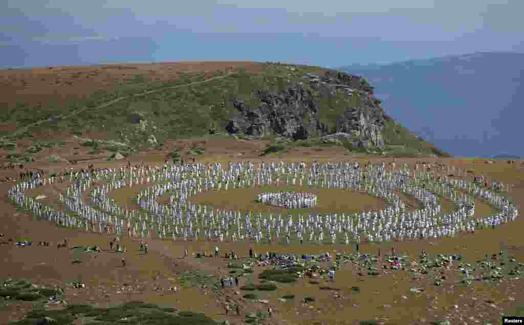 Followers of the Universal White Brotherhood, an esoteric society that combines Christianity and Indian mysticism set up by Bulgarian Peter Deunov in the 1920s, perform a dance-like ritual called "paneurhythmy" in Rila Mountain, Bulgaria, Aug.19, 2019.