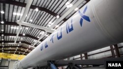 A SpaceX Falcon 9 rocket being prepared for the company's first Commercial Resupply Services mission to send a Dragon spacecraft to the International Space Station, September 30, 2012. (NASA/Ben Smegelsky)