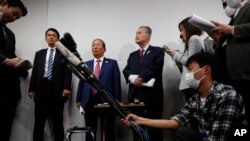 The Tokyo 2020 Organizing Committee's Toshiro Muto, center left, and Yoshiro Mori, center right, listen to questions from the media during a news conference in Tokyo, March 4, 2020.