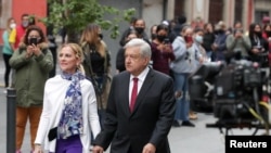 Mexico's President Andres Manuel Lopez Obrador and his wife Beatriz Gutierrez walk near a polling station outside the National Palace, in Mexico City, June 6, 2021. 