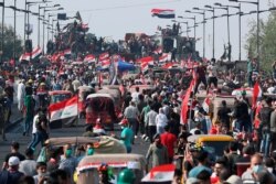 Anti-government protesters gather on the Joumhouriya Bridge leading to the Green Zone, during a demonstration in Baghdad, Iraq, Oct. 31, 2019.
