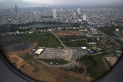 FILE - The cleaning operation of the area that was used for storing Agent Orange is seen from a plane taking off from Danang international airport.
