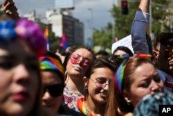 FILE - Participants take part in a gay pride parade in Santiago, Chile, Nov. 17, 2018.