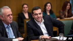 Greek Prime Minister Alexis Tsipras, right and ministers of his government attend a cabinet meeting in the parliament in Athens, Jan. 28, 2019. 