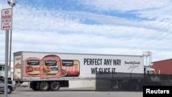 FILE - A truck arrives at Smithfield Foods' pork plant in Smithfield, Virginia, Oct. 17, 2019.