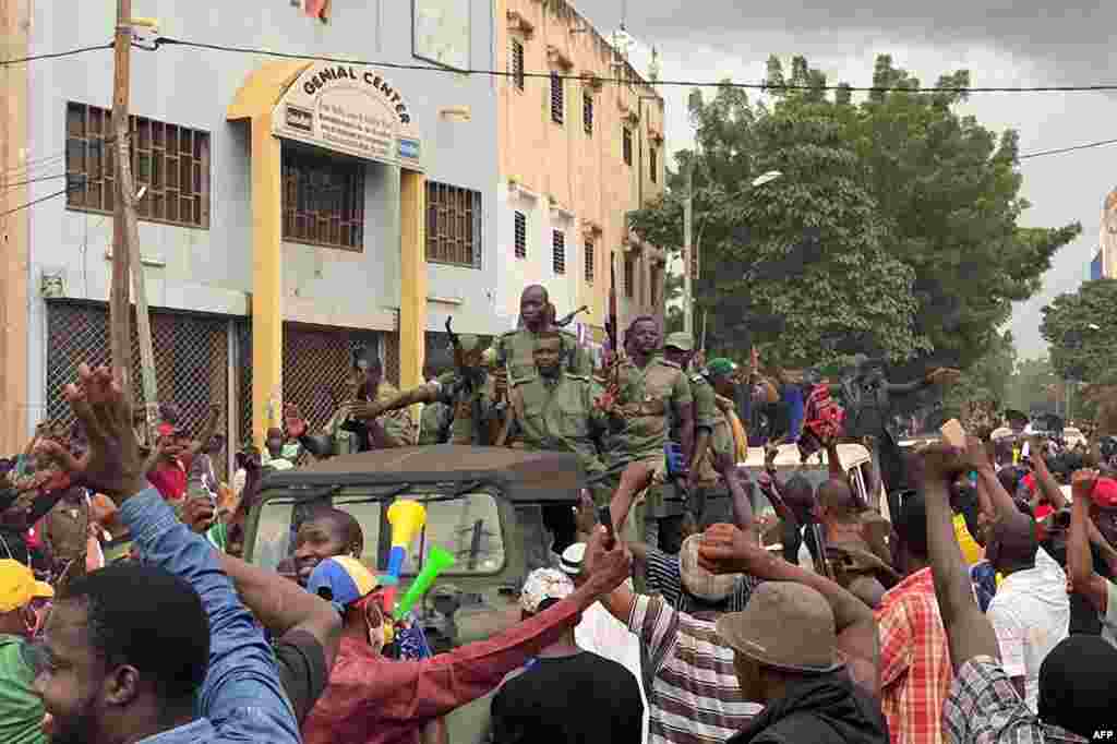 Malian soldiers arrive at Independence Square in Bamako. Prime Minister Boubou Cisse called for &quot;fraternal dialogue&quot; with soldiers who seized a key military garrison and have triggered fears of a coup attempt. 