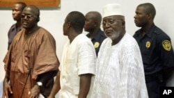 FILE: Allieu Kondewa, Moinina Fofana and Sam Hinga Norman, from left, who are accused of war crimes during the 1991 to 2002 conflict in Sierra Leone, rise at the start of the trials of the U.N.-backed war crimes court for Sierra Leone in Freetown, Sierra Leone, on June 3, 2004.