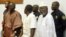 FILE: Allieu Kondewa, Moinina Fofana and Sam Hinga Norman, from left, who are accused of war crimes during the 1991 to 2002 conflict in Sierra Leone, rise at the start of the trials of the U.N.-backed war crimes court for Sierra Leone in Freetown, Sierra Leone, on June 3, 2004.