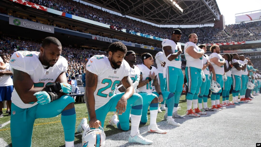 Jelani Jenkins, Arian Foster, Michael Thomas and Kenny Stills kneel during the national anthem, Sept. 11, 2016.