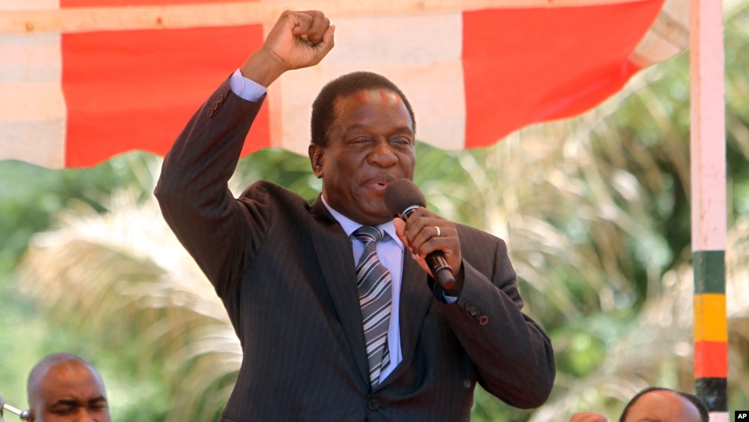 FILE - Then-Zimbabwean Vice President Emmerson Mnangagwa greets party supporters at the ZANU-PF headquarters in Harare, Feb, 10, 2016.