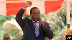 FILE - Then-Zimbabwean Vice President Emmerson Mnangagwa greets party supporters at the ZANU-PF headquarters in Harare, Feb, 10, 2016.