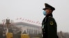 FILE - A paramilitary police officer stands guard near the Great Hall of the People in Beijing, China, March 5, 2021. A U.S. intelligence report released April 13, 2021, warned of China's threat to the U.S.
