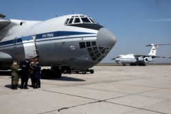 Russian military planes with medical supplies sit at Batajnica military airport near Belgrade, Serbia, April 3, 2020. The Russian Defense Ministry said it has sent medical and disinfection teams to Serbia to help fight the coronavirus.