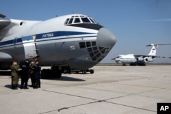 Russian military planes with medical supplies sit at Batajnica military airport near Belgrade, Serbia, April 3, 2020. The Russian Defense Ministry said it has sent medical and disinfection teams to Serbia to help fight the coronavirus.