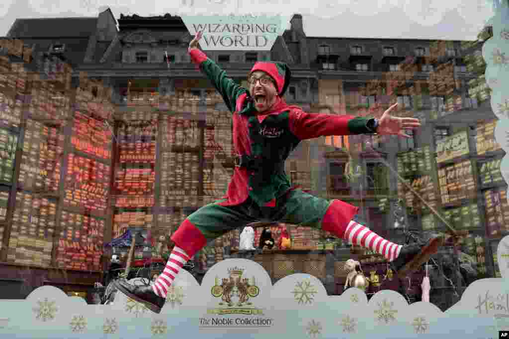 A Hamleys elf performs during the annual unveiling of the Hamleys Christmas Windows on Regent Street in London.