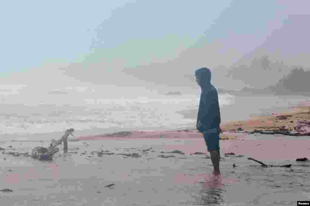 A man stands on the beach as Hurricane Irma slams across islands in the northern Caribbean on Wednesday, in Luquillo, Puerto Rico, Sept. 6, 2017.