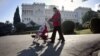 A family walks in front of the Livadia palace in Yalta on March 5, 2014. The palace was a summer residence of the last Russian tsar, Nicholas II, and his family. 