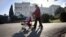 A family walks in front of the Livadia palace in Yalta on March 5, 2014. The palace was a summer residence of the last Russian tsar, Nicholas II, and his family. 
