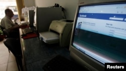 FILE - A man sits in an internet cafe in Cairo May 18, 2010. Egypt’s parliament has passed a law giving the state powers to block social media accounts and penalize journalists held to be publishing fake news.