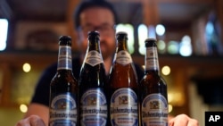 FILE - Head Brewmaster Tobias Zollo poses behind non alcoholic beer at the Weihenstephan brewery in Freising, Germany, Friday, Sept. 20, 2024. (AP Photo/Matthias Schrader)