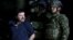 Joaquin "El Chapo" Guzman is escorted by soldiers during a presentation at the hangar belonging to the office of the Attorney General in Mexico City, Mexico, Jan. 8, 2016. 