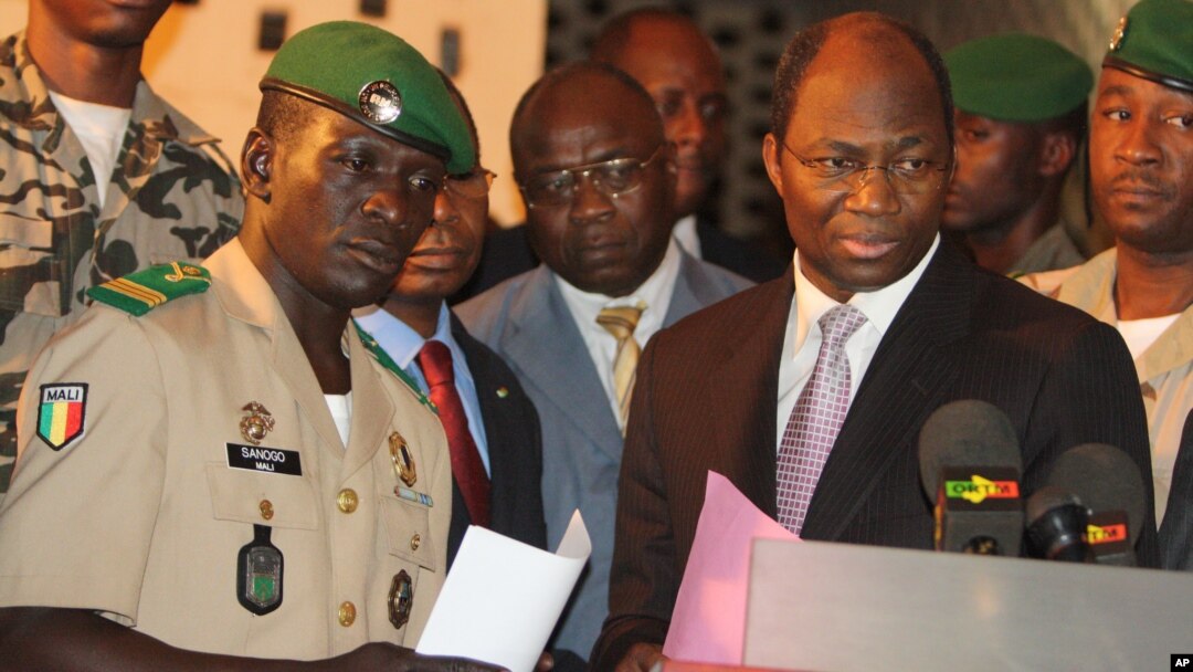 Coup leader Capt. Amadou Haya Sanogo, left, stands with Burkina Faso FM Djibrill Bassole, right, as they address the media at junta headquarters in Kati, outside Bamako, Mali, April 6, 2012.