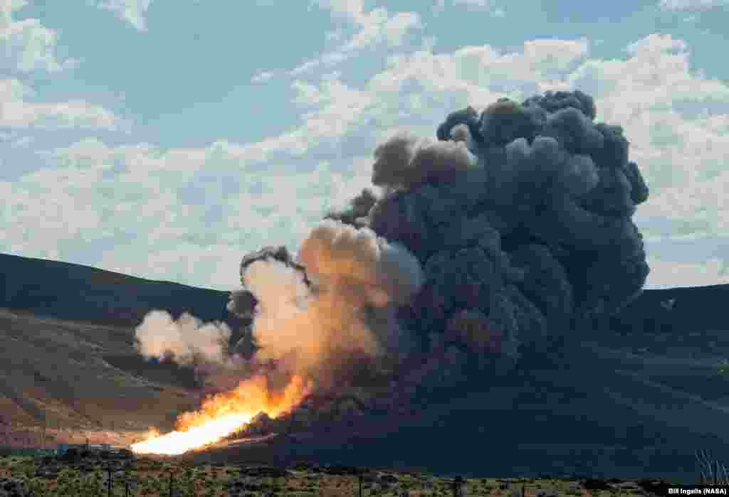 The second and final qualification motor (QM-2) test for the Space Launch System&rsquo;s booster is seen at Orbital ATK Propulsion Systems test facilities in Promontory, Utah. During the Space Launch System flight the boosters will provide more than 75 percent of the thrust needed to escape the gravitational pull of the Earth, the first step on NASA&rsquo;s Journey to Mars.