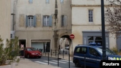 A French gendarme vehicle patrols the street near a building where special police forces entered several apartments in the southern town of Lunel, Jan. 27, 2015, in an operation aimed at breaking up jihadist networks.